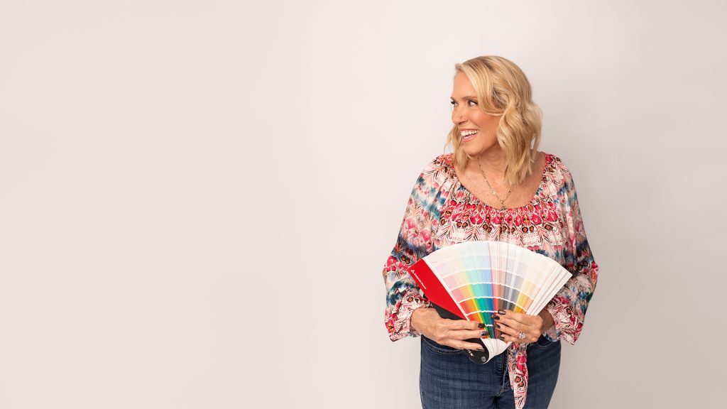 Color consultant reviewing paint swatches and palettes for a Naples, FL home during a professional color consultation.