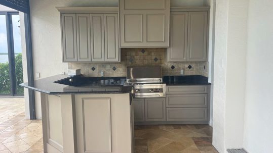 Beautifully refinished kitchen cabinets in a modern, updated color that enhances the style and brightness of the space.