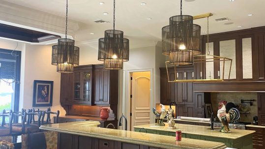 Refinished kitchen cabinets in a Naples, Florida home featuring a modern, updated color palette and smooth professional finish.