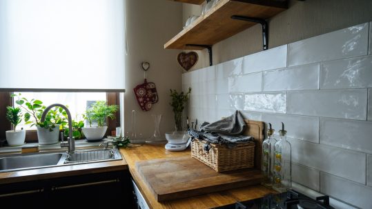 Soothing kitchen color palette featuring soft blues, warm neutrals, sage green, and other calming paint colors for an organized kitchen in Naples, Florida.